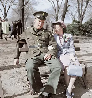 Purse: Soldier and friend sit on a park bench in