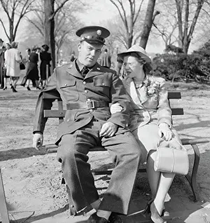 Purse: Soldier and friend sit on a park bench in