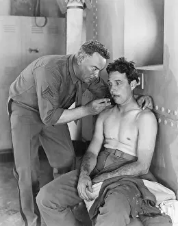 Exhausting: A soldier helps his comrade and lets him smoke his pipe