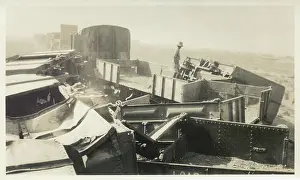 Sepia Images: Soldier inspecting destroyed train, Iraq
