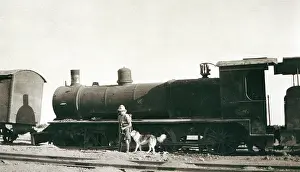 Sepia Images: Soldier inspecting sabotaged train, Iraq