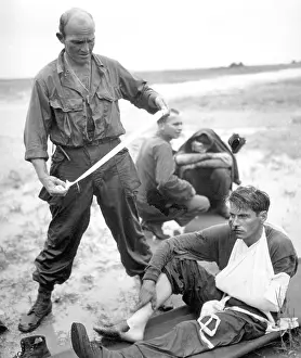 Leyte: Soldiers aided by corpsmen after their tank hit