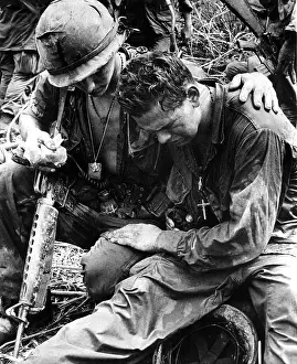Trauma: Two soldiers comfort each other under the ?