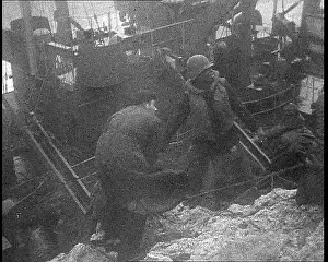 Shipwrecked: Two Soldiers Helping Another Climb From a Shipwrecked