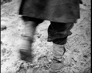 Trudging: Soldiers Legs Trudging Through a Muddy Camp