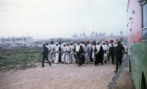 Easterni: Soldiers with Omani elders walking in the sand. in Oman