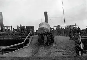 Fully: Soldiers push covered wagon, 1916
