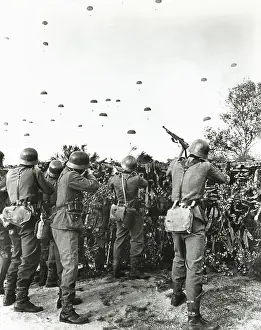 Mid Air: Soldiers shooting at enemy parachuting into field -