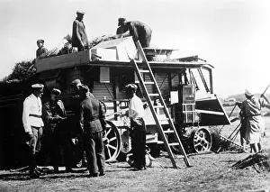 Threshing: Soldiers stand by a threshing machine