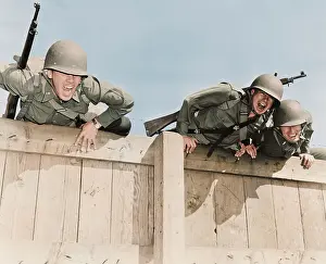 Barrier: Soldiers topping the six foot wall at Camp
