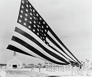 Loyalty: Soldiers unfolding Garrison flags at Fort