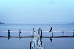Midwestern: Solitary Anonymous Silhouetted Man Sitting on