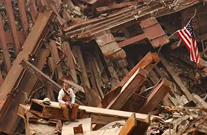 21st Century: Solo firefighter sitting on a beam in the wreckage