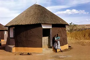 Enclaves: Sotho woman standing outside a hut