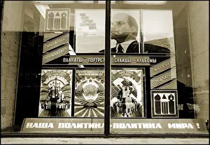 Muscovites: Soviet-era posters displayed in a window - Moscow