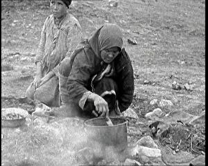 British Pathé Ltd: Soviet Woman Cooking By the Bank of a River
