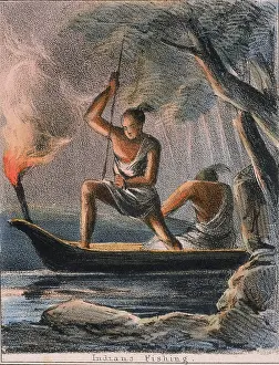 Spearing: Spearing fish at night using flares, India. From