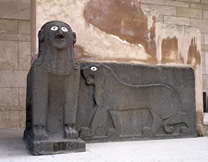Tell: Sphinx and a lion in relief. Basalt. Syria