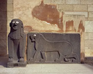 Tell: Sphinx and a lion in relief. Basalt. Syria