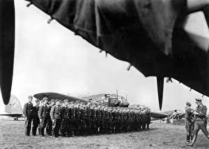 Backround: A squadron crew of a bomber wing has lined up to muster