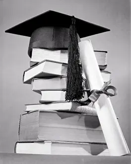 Mortarboard: Stack of Books with Diploma Leaning on Side and