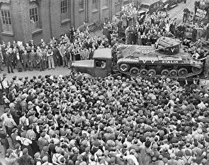 Christened: A Stalin tank makes its way through crowds of