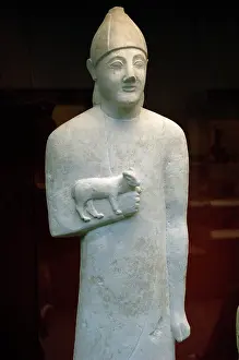 Devout: Statue of a devotee holding a small animal as an offering. L