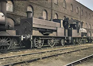 Steam engine at side of building