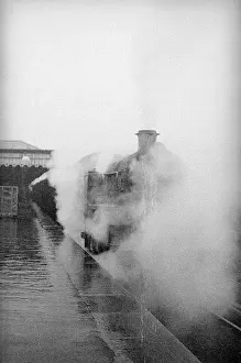 Enveloped: Steam engine at a station on the Redhill Reading line