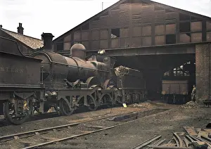 Handled: Steam engine and tender on a railway track