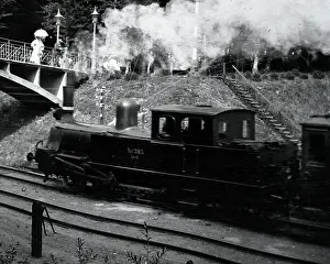 Incline: Steam train approaching a bridge