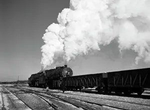 Fired: Steam train in a rail yard blowing clouds of smoke sky high