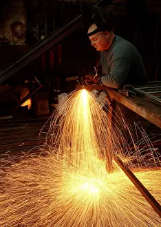 Sparks: A steelworker makes a shower of sparks in his workshop