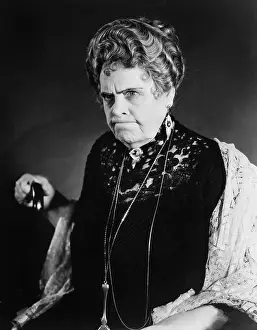 Seriousness: A very stern looking woman holding onto her cane