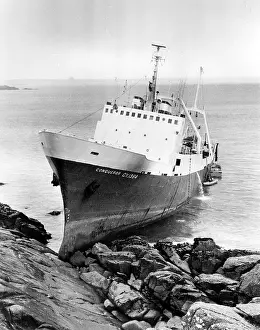 Mousehole: Stern trawler Conqueror on rocks at Mousehole, Cornwall