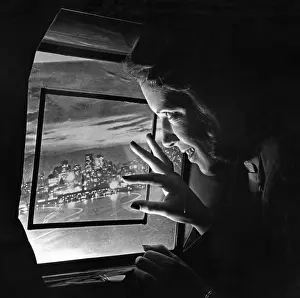 Stewardesses: A stewardess looking through an airplane window, 1938