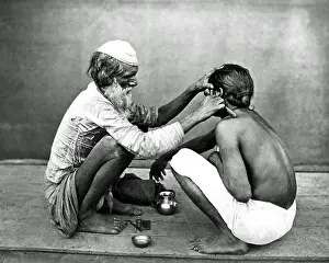 Street barber at work, India