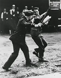 Affecting: A striker dodges policeman's night stick during