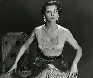 Tops: Striking brunette model - tight top, silk skirt - seated