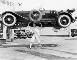 Strongman: Strong man lifting a car over his head