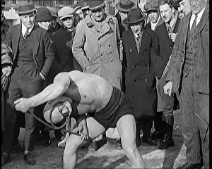 Bending: A Strongman Bending An Iron Bar Around His Head