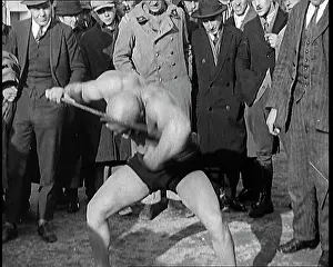 Bending: A Strongman Bending An Iron Bar Around His Head