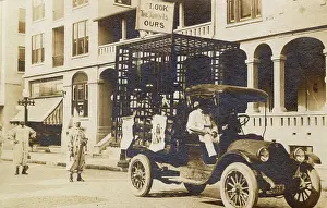 Ours: Studebaker flatbed truck with men in cage, USA