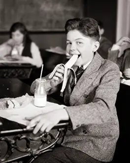 Waxed: Student Eating Snack at his School Desk