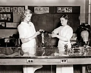 Cosmetology: Two Student Hairstylists working on Practice Wig