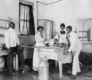 4 People: Students operating a small cotton gin at the Tuskegee