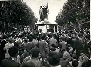 Boisterous: Students stand on top of bus in Latin Quarter of Paris