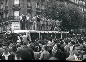 Boisterous: Students stand on top of bus in Latin Quarter of Paris