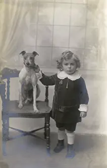 Cuffs: Studio portrait, boy with Jack Russell terrier