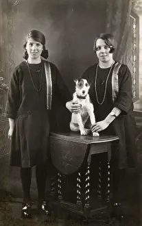 Flap: Studio portrait, two girls with terrier